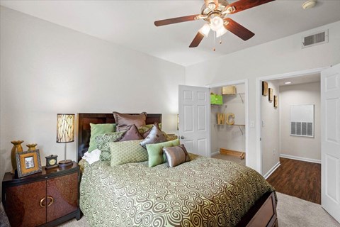 a bedroom with a bed and a ceiling fan